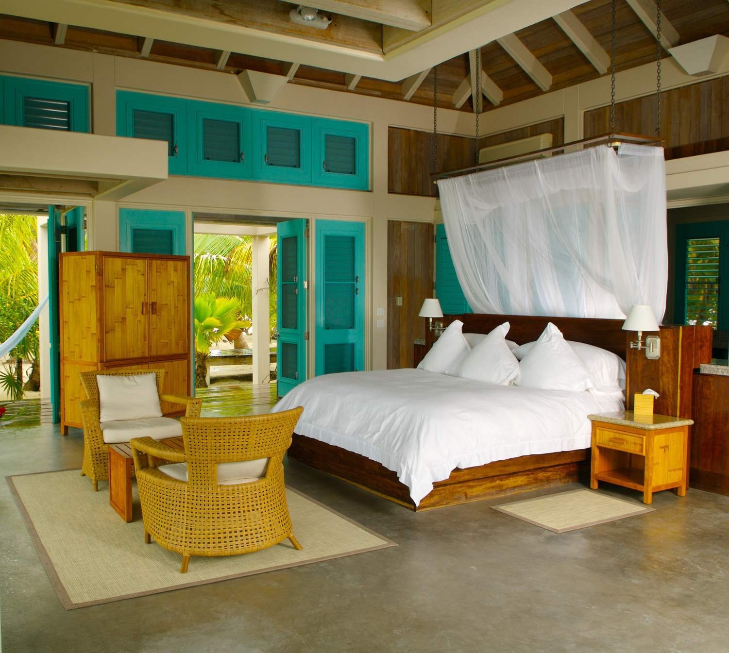 A villa's bedroom at Cayo Espanto, decorated with wooden accents.