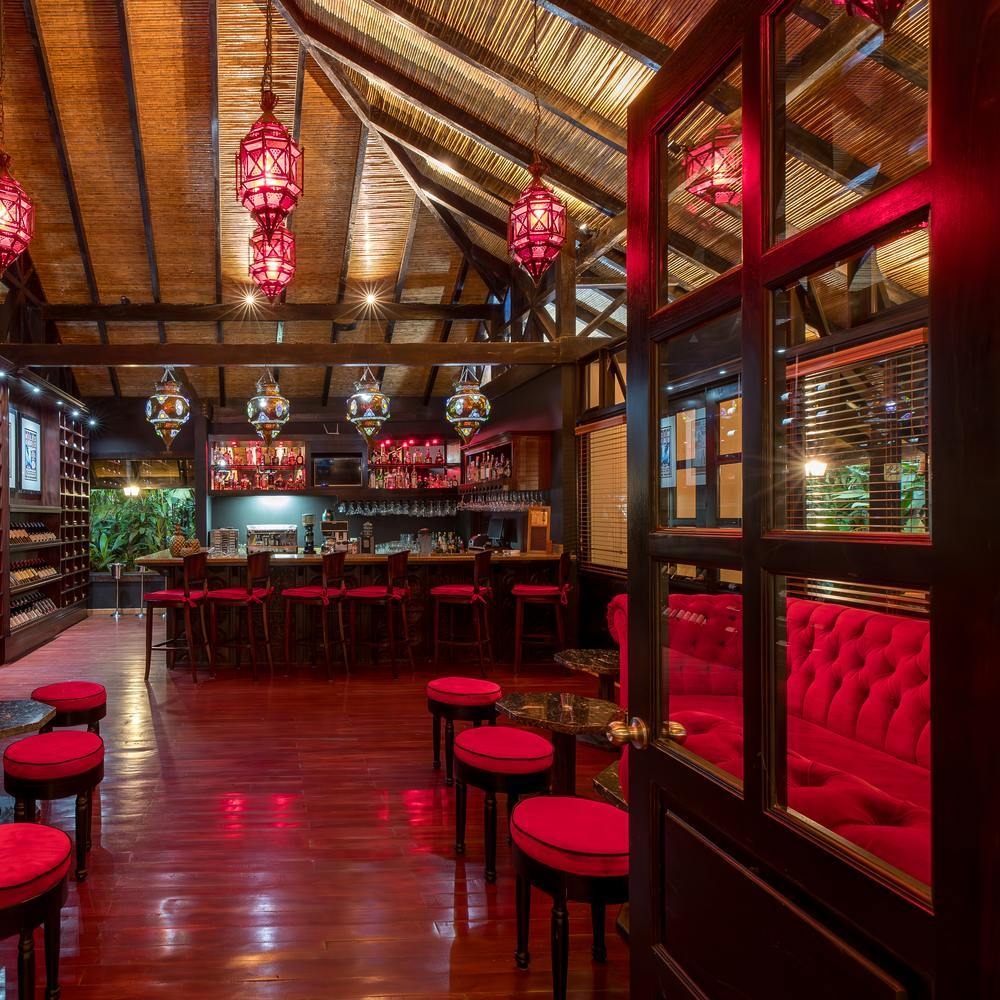 Hotel bar decorated with red furnishings at Hotel Rio Celeste, Costa Rica