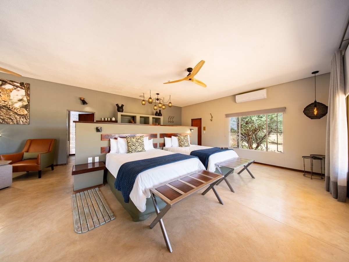 A twin bedroom at Okonjima Plains Camp