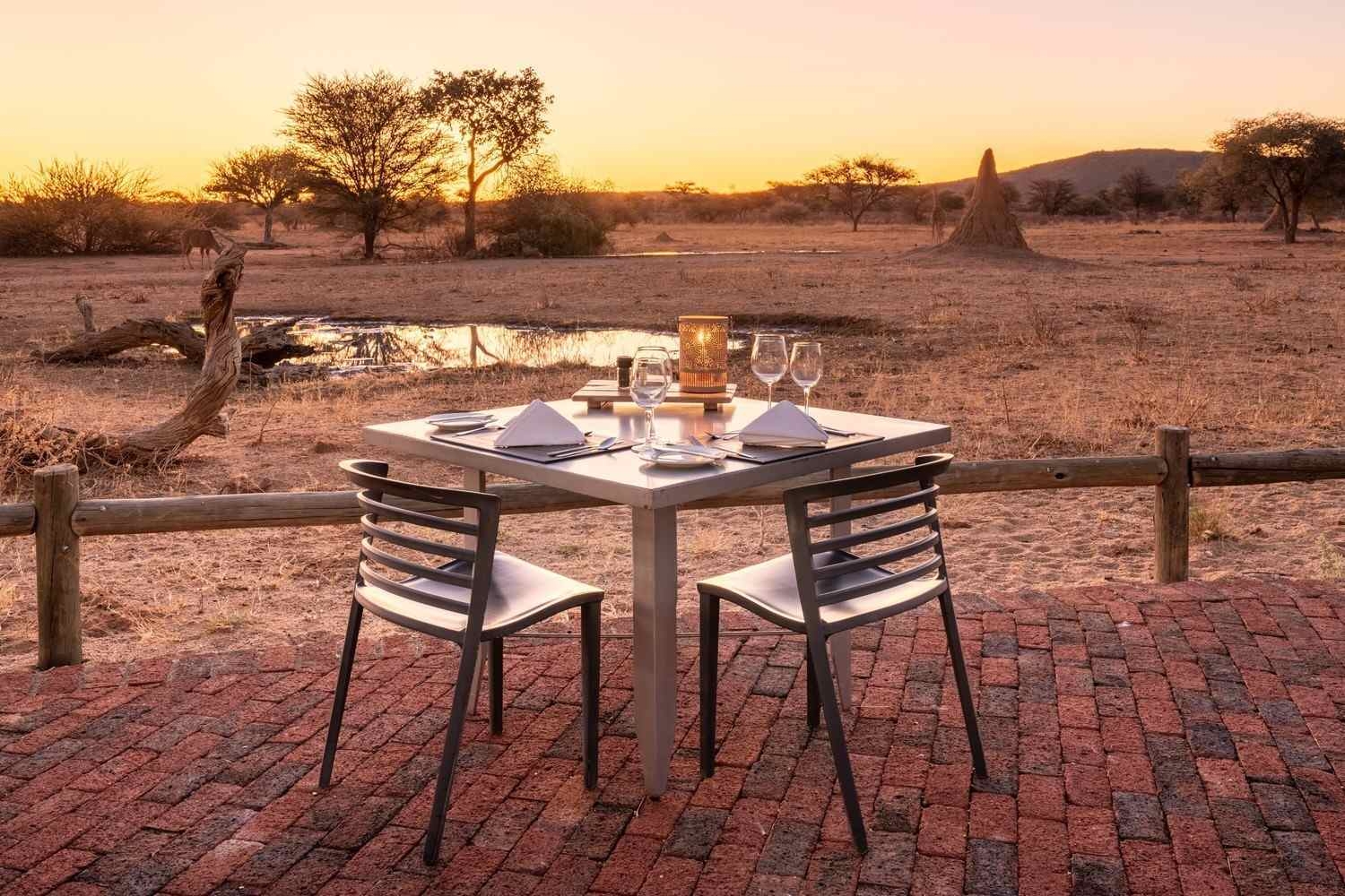 Dinner for two overlooking the watering hole at Okonjima Plains Camp