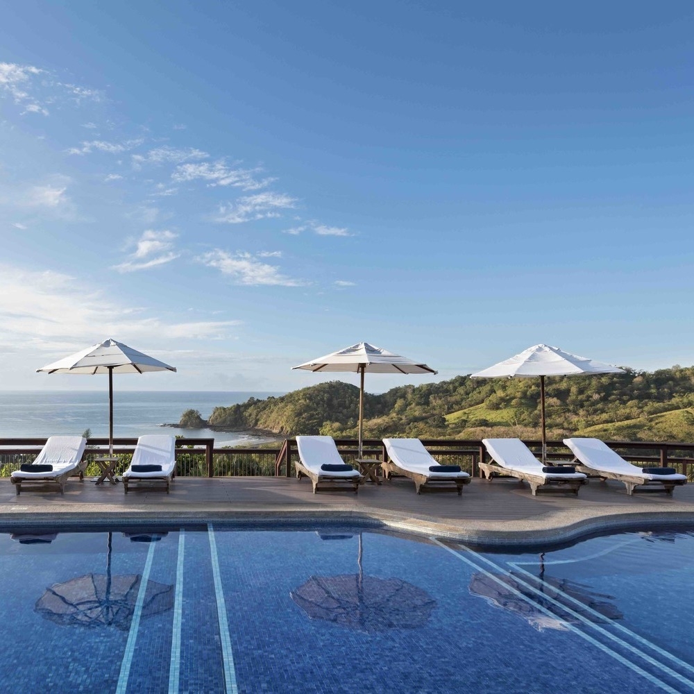 Outdoor pool with sun loungers at Hotel Punta Islita, Costa Rica