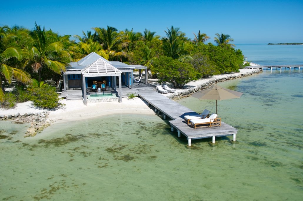 An aerial image of one of Cayo Espanto's beachfront villas with a private beach and dock.