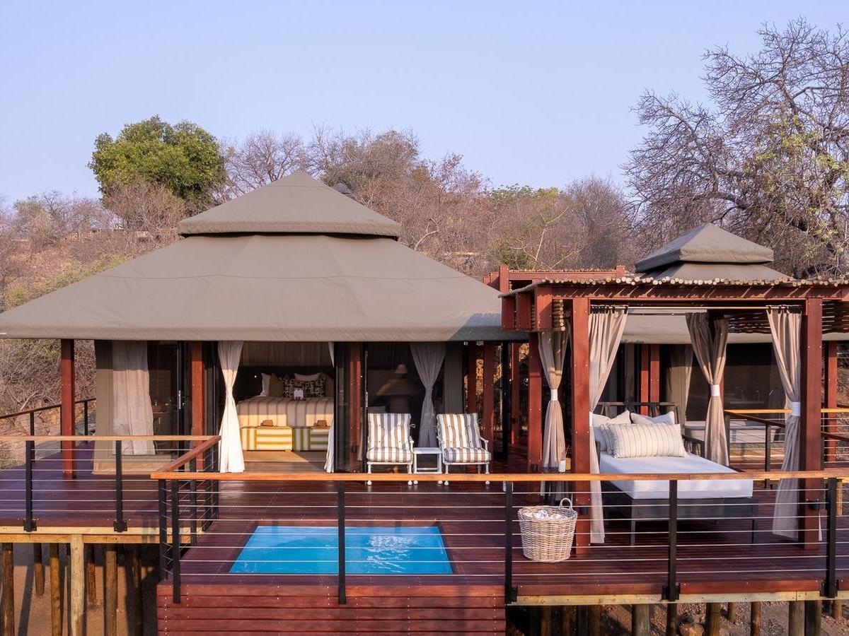 Exterior of a luxury safari tent with a private wooden deck and pool at Simbavati Hilltop Lodge.
