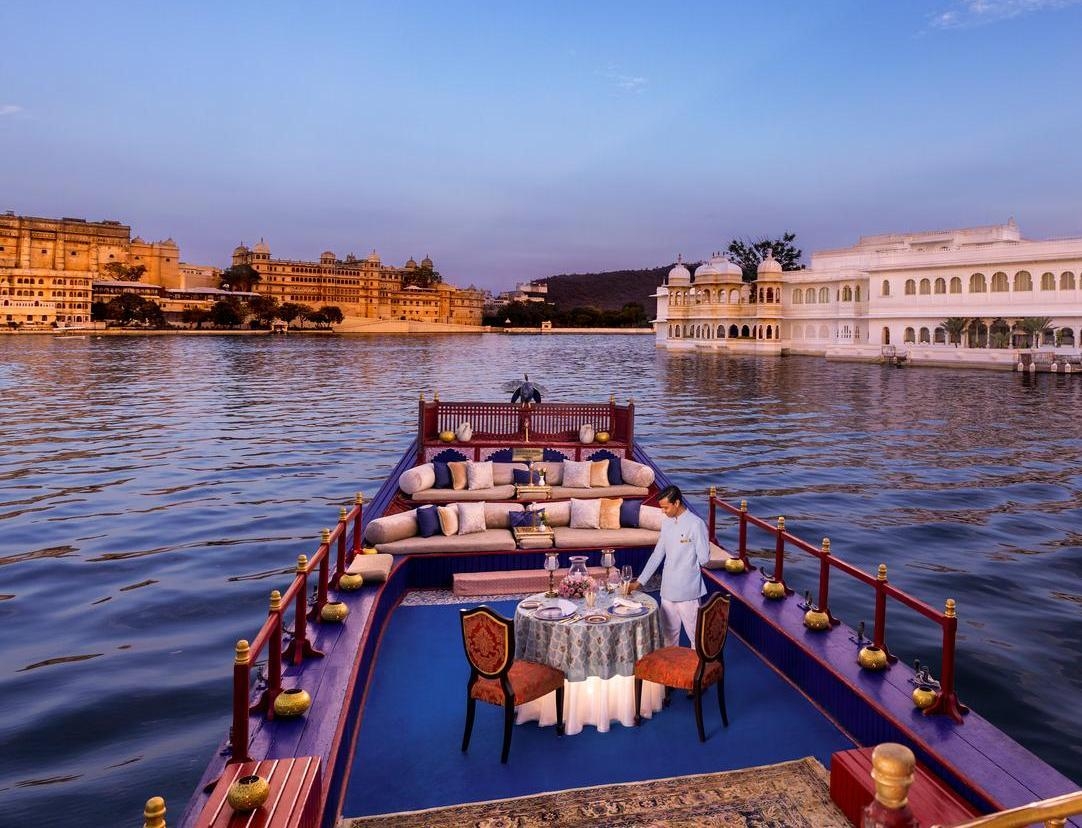 The Taj Lake Palace's sailing boat fitted with a dining table surrounded by lanterns.