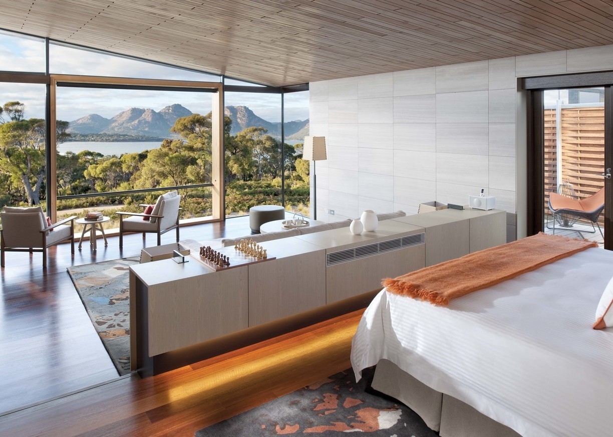A bedroom in the Tasmania Luxury Suite with sea views at Saffire Freycinet