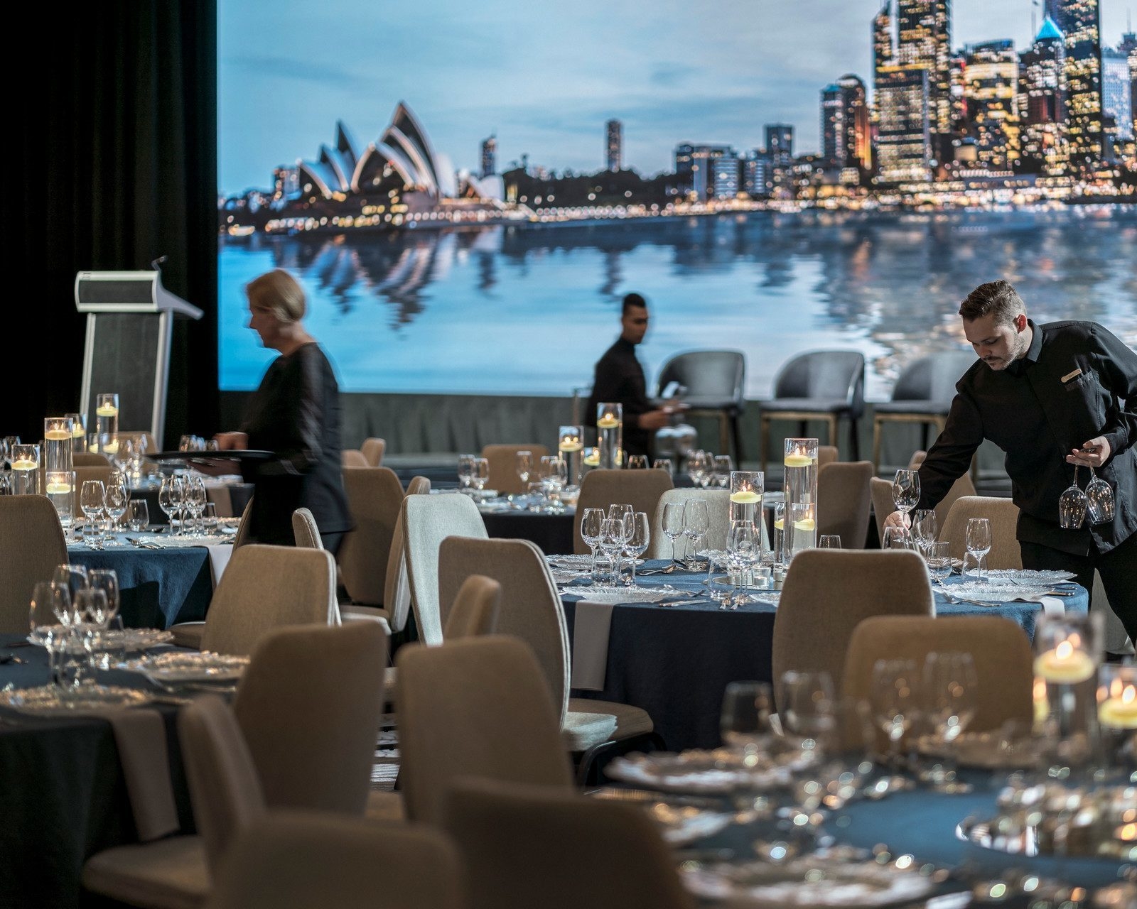 Staff setting up dining tables at Four Seasons Sydney