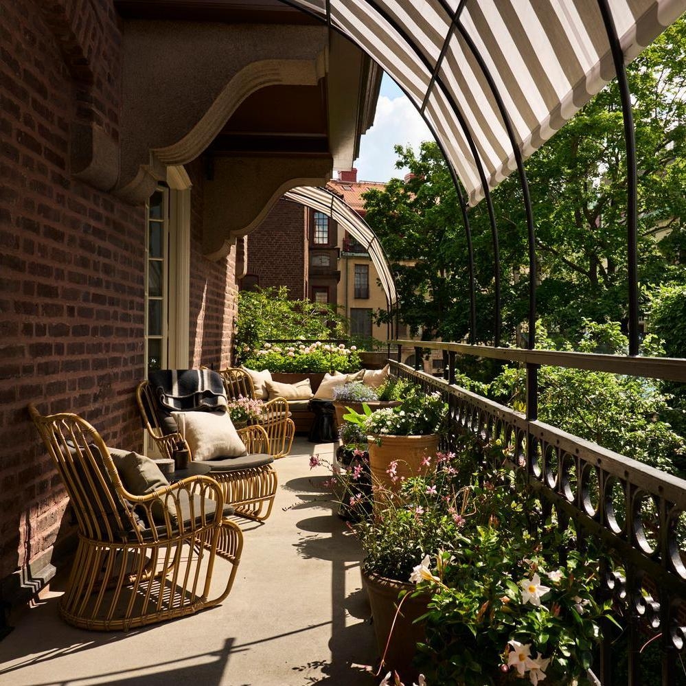 The furnished terrace area at Ett Hem, surrounded by greenery.