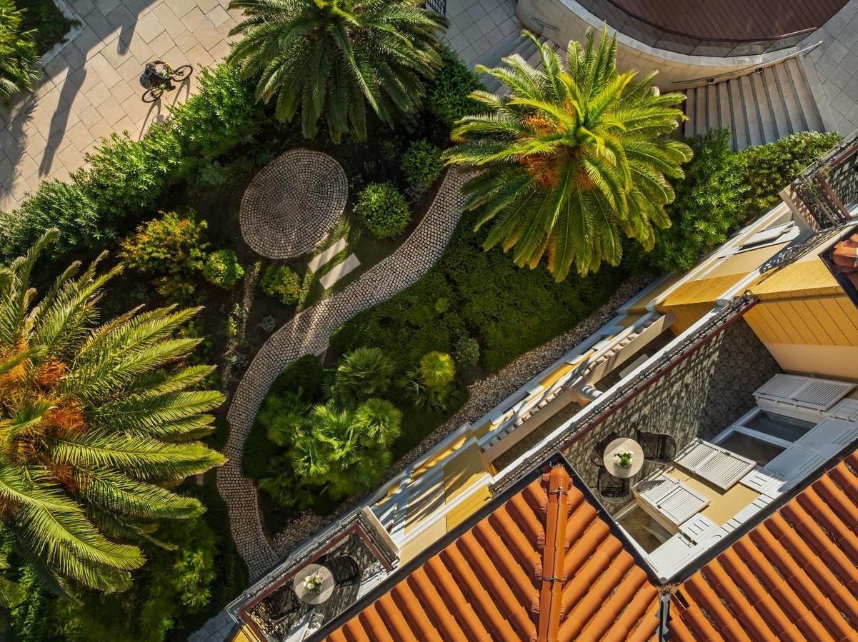 Aerial view of the exterior of Boutique Hotel Alhambra in Croatia showing manicured gardens and a pathway