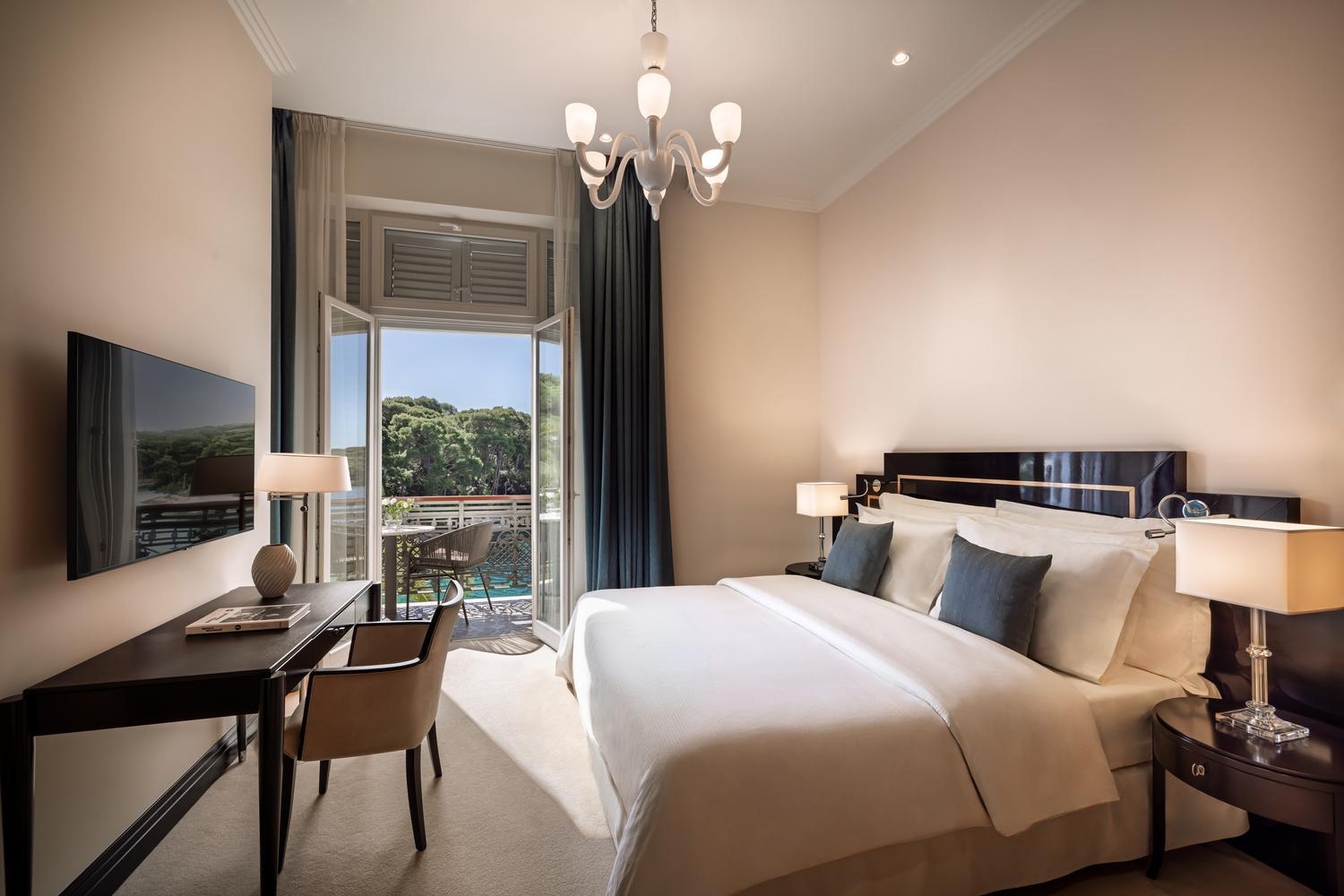 A double bedroom with balcony at Boutique Hotel Alhambra in Croatia
