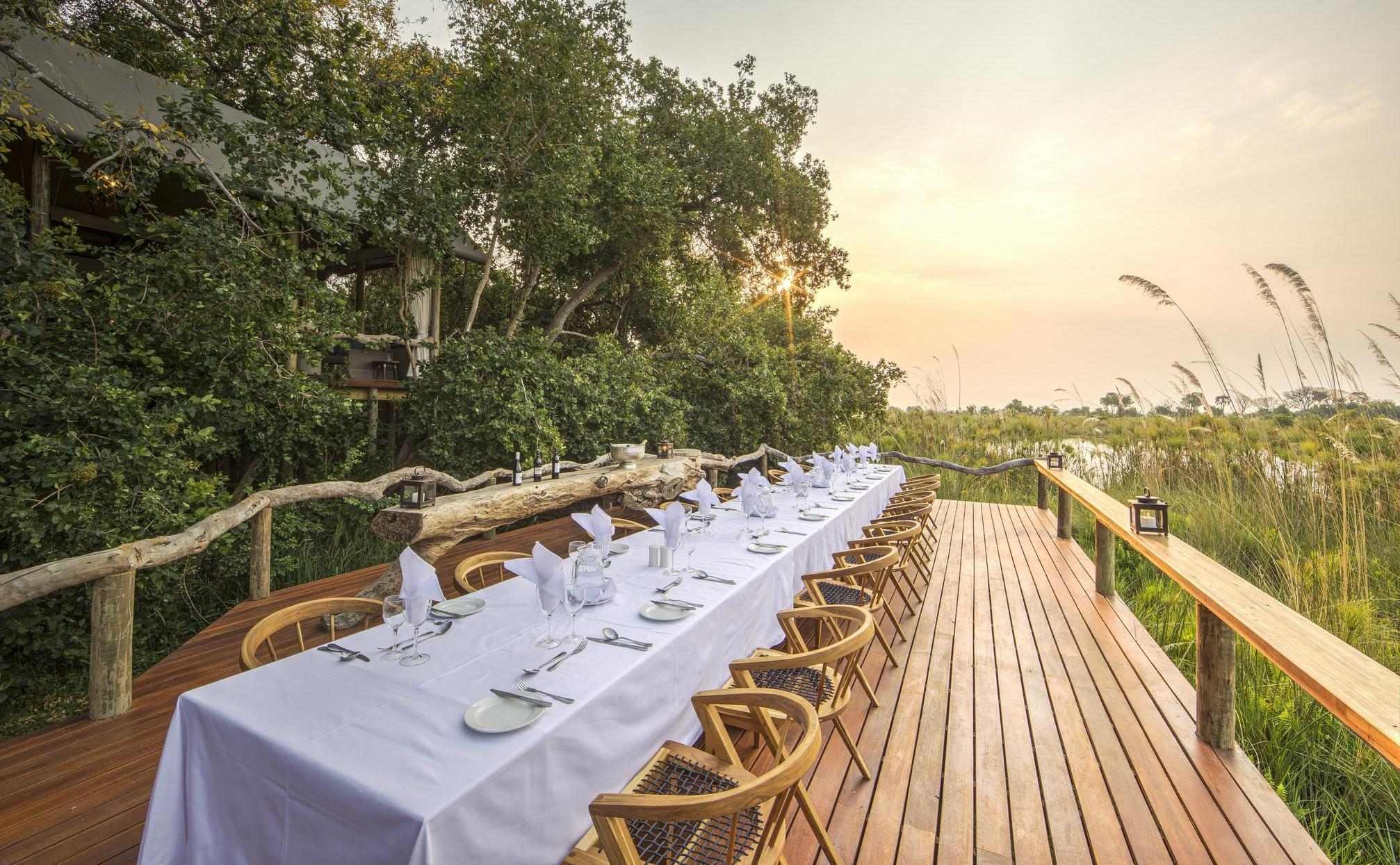 The open-air dining area at Shinde Camp, featuring a family-style table.
