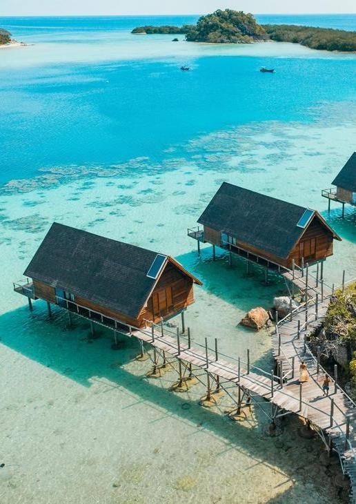 Aerial view of overwater bungalows at Bawah Reserve in Indonesia