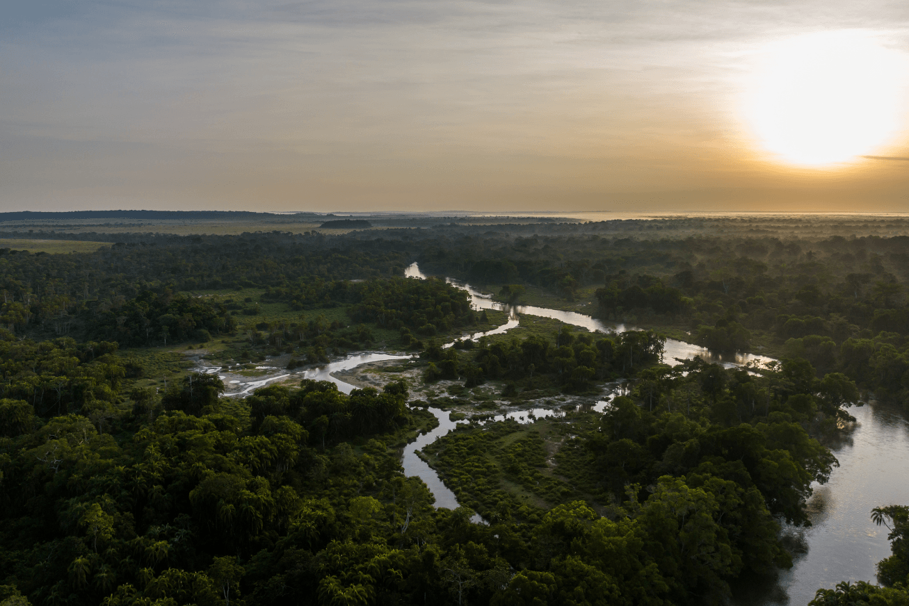 A wide view of the waterways and forests of the Lango baï at sunset