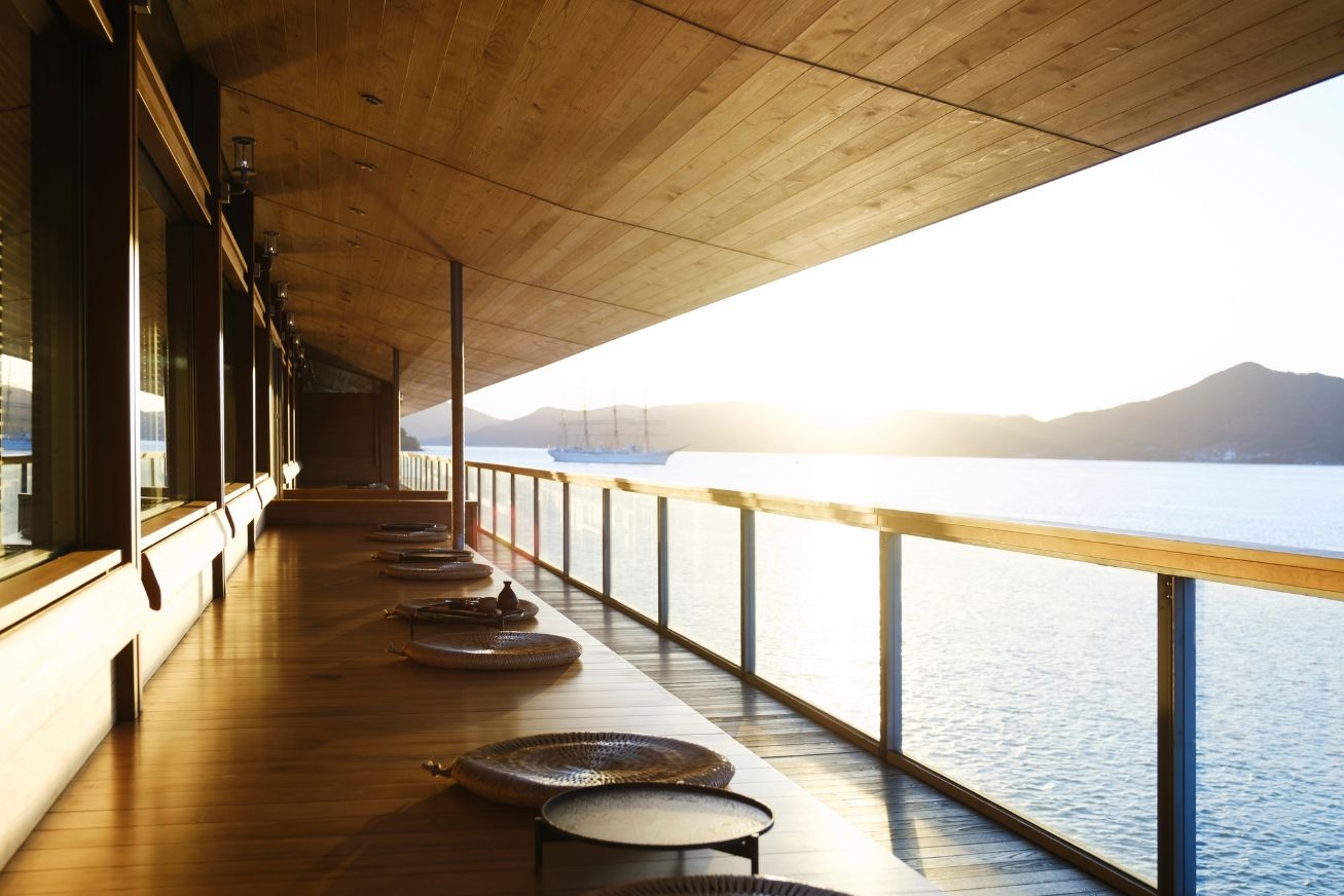 Open-air covered terrace on a ship with floor cushions and low tables
