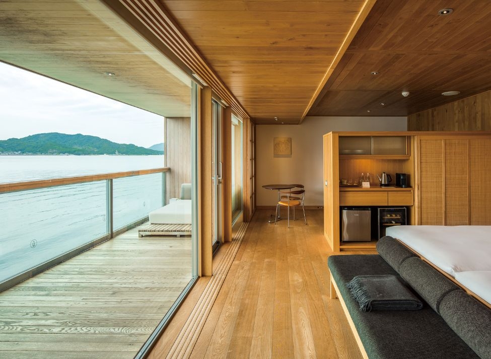 A wood-panelled ship cabin with a terrace overlooking the sea