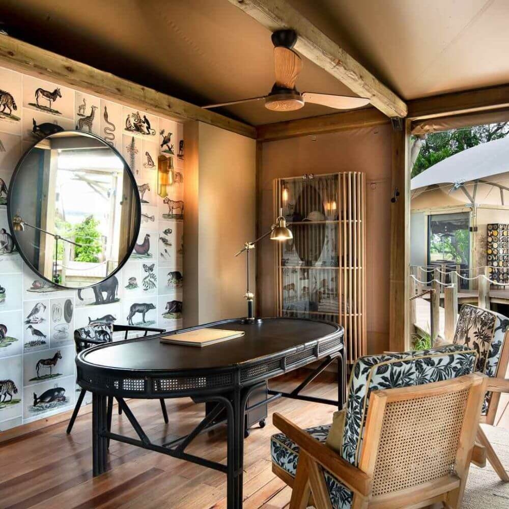 Reading area with two chairs, a table and a wall mirror