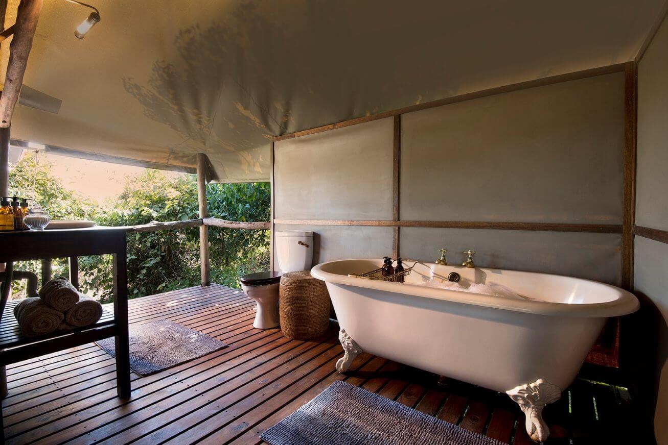 Clawfoot bathtub in an open-air tented bathroom