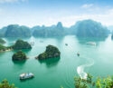 High-angle view of green limestone karsts and islands scattered across the turquoise waters of Ha Long Bay, Vietnam.