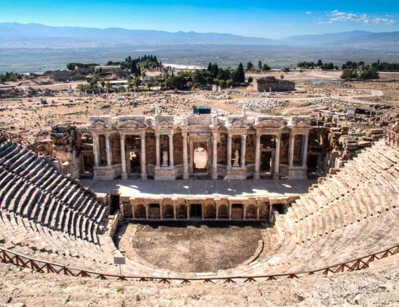 The grand stone facade and tiered seating of an ancient Roman theatre during luxury Turkey Asia tours.