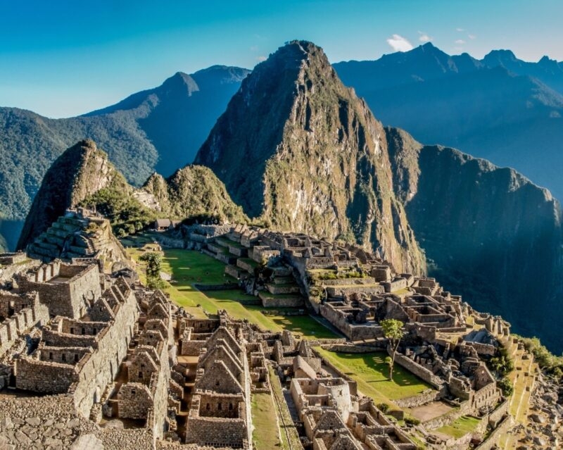 Machu Picchu, ancient Incan city ruins nestled between mountain peaks in Peru.
