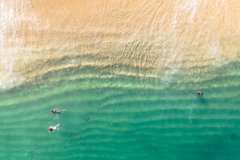 aerial photo of beach with green ocean at Los Cabos, Mexico