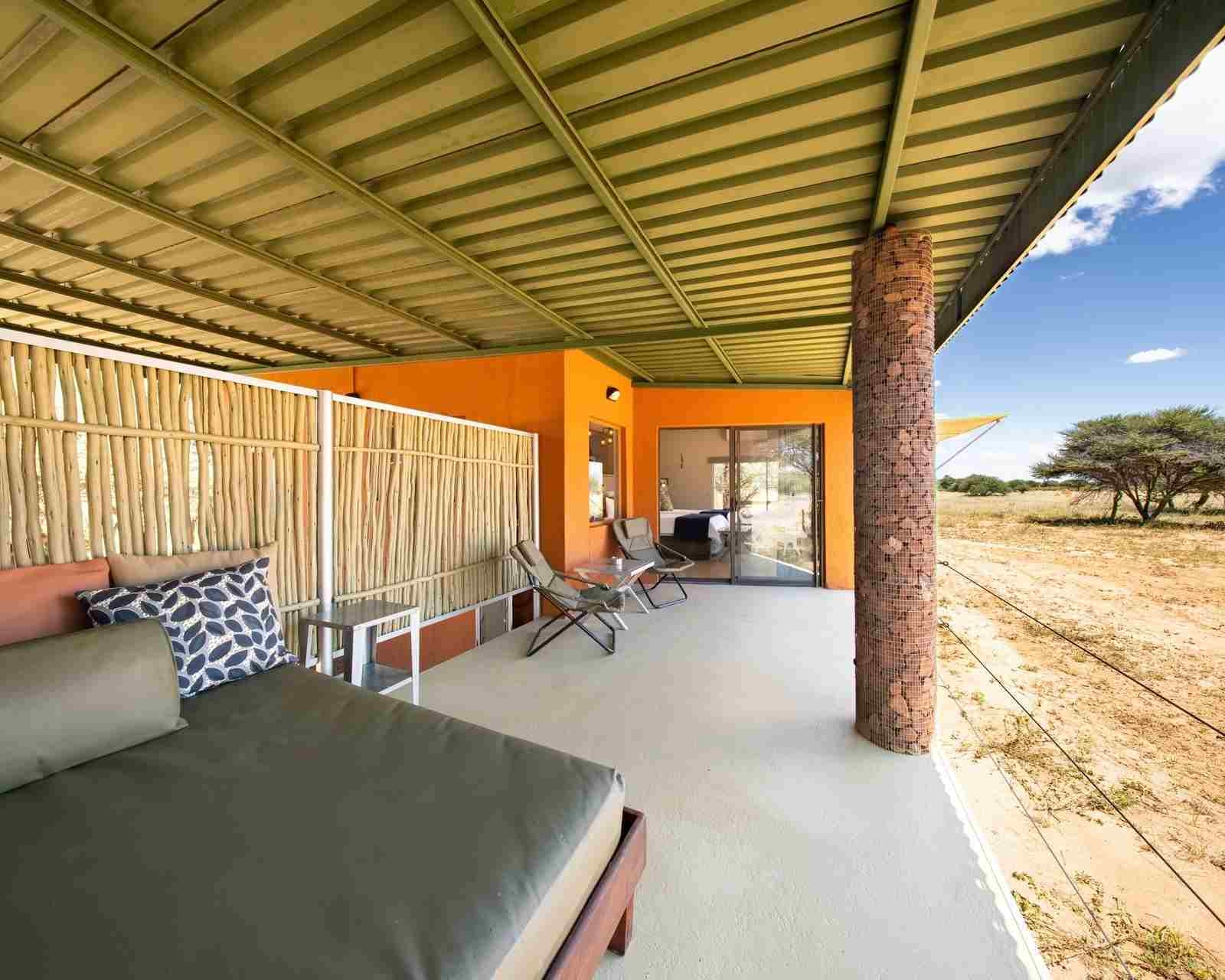 A sheltered verandah looking onto grassy plains at Okonjima Plains Camp
