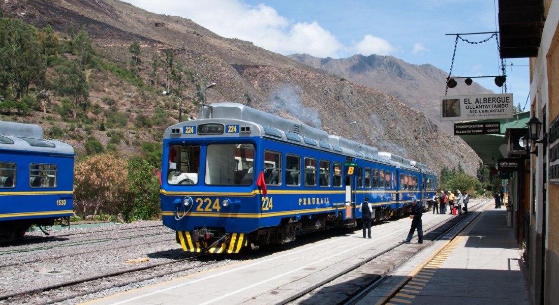 Blue Vistadome train pulling out of the station on it's journey between the Sacred Valley and Machu Picchu, Peru