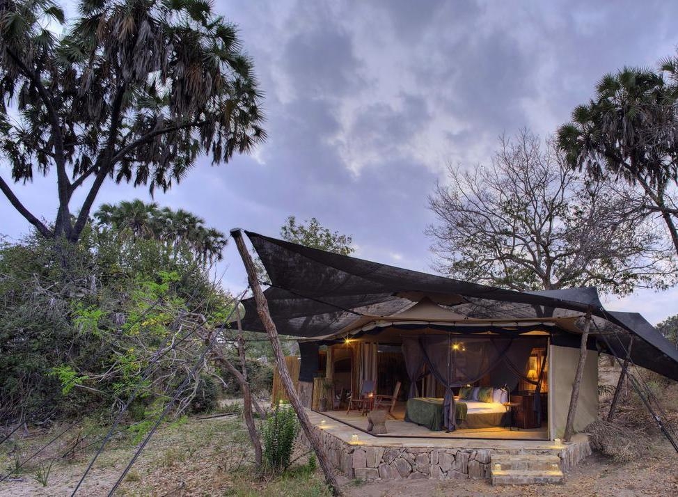 An exterior view of one of Roho ya Selous's bedrooms, featuring canvas roofing and walls.