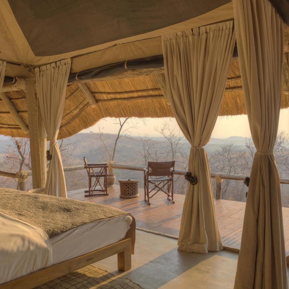 A panoramic bedroom at Ikuka Safari Camp overlooking the bush.