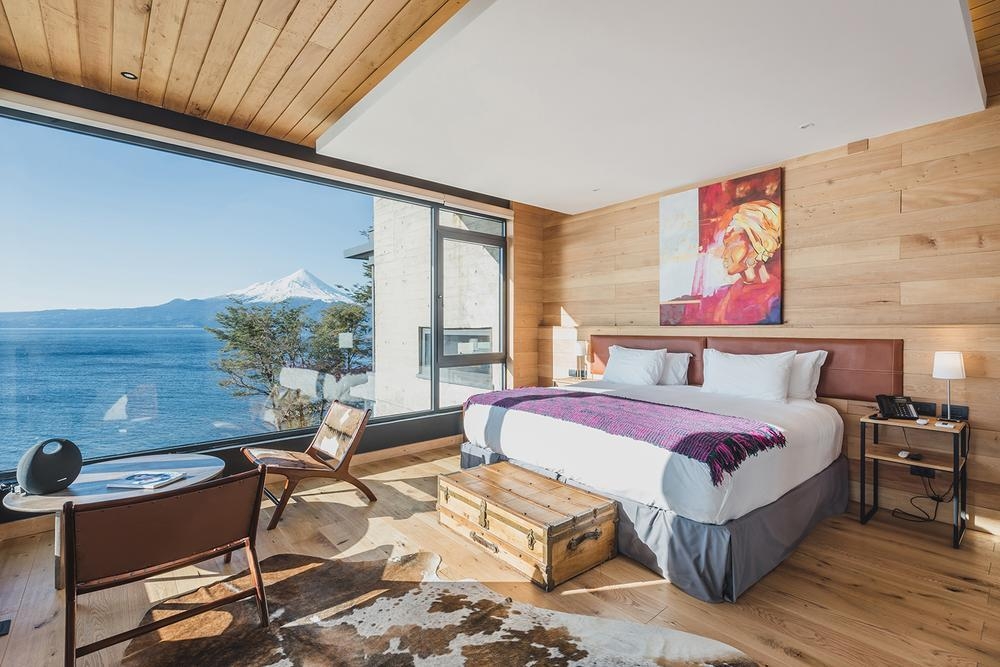 The bedroom of one of Hotel AWA's rooms overlooking the lake.