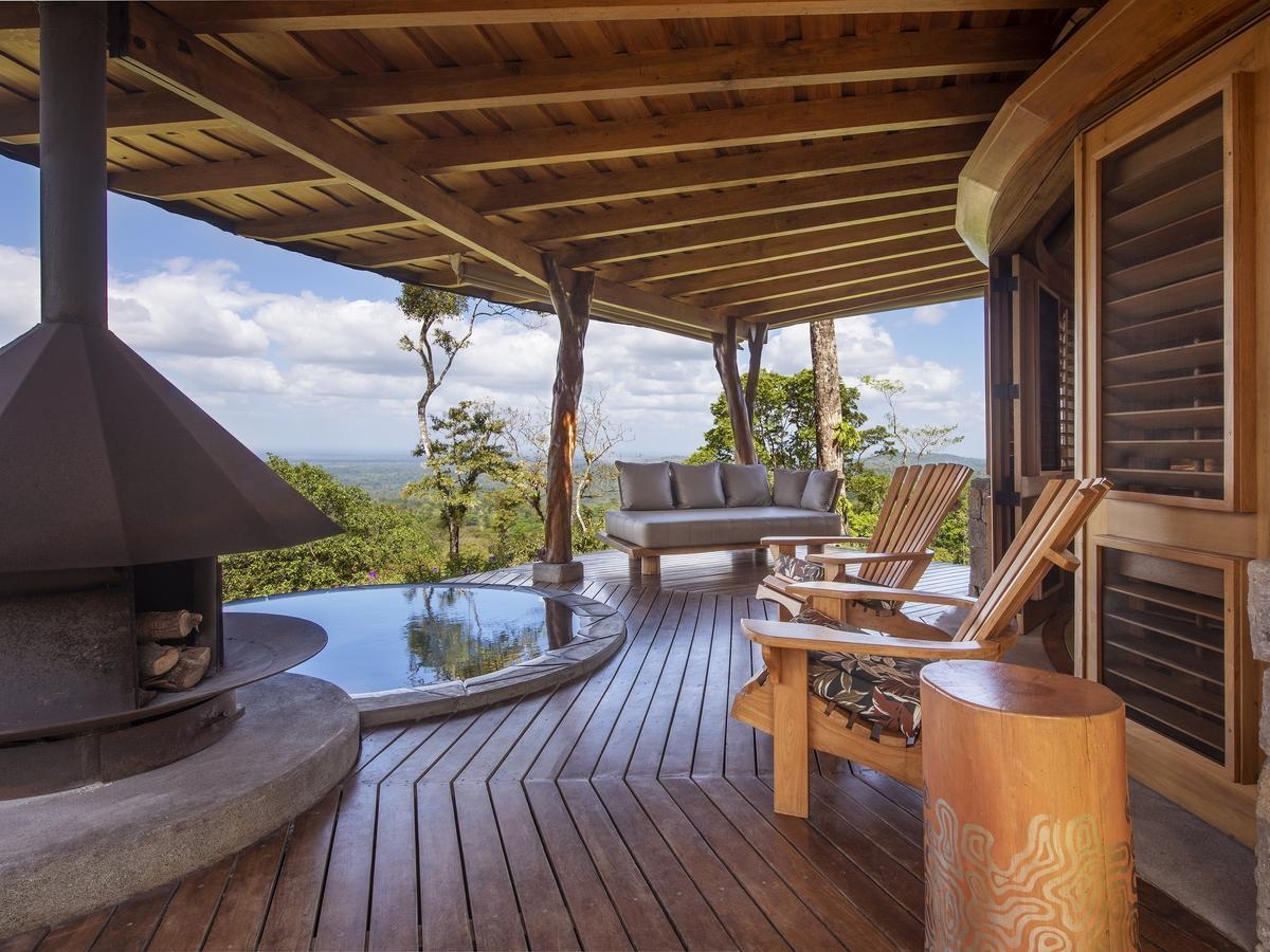 Open air terrace with seating and pool at Origins Lodge, Costa Rica