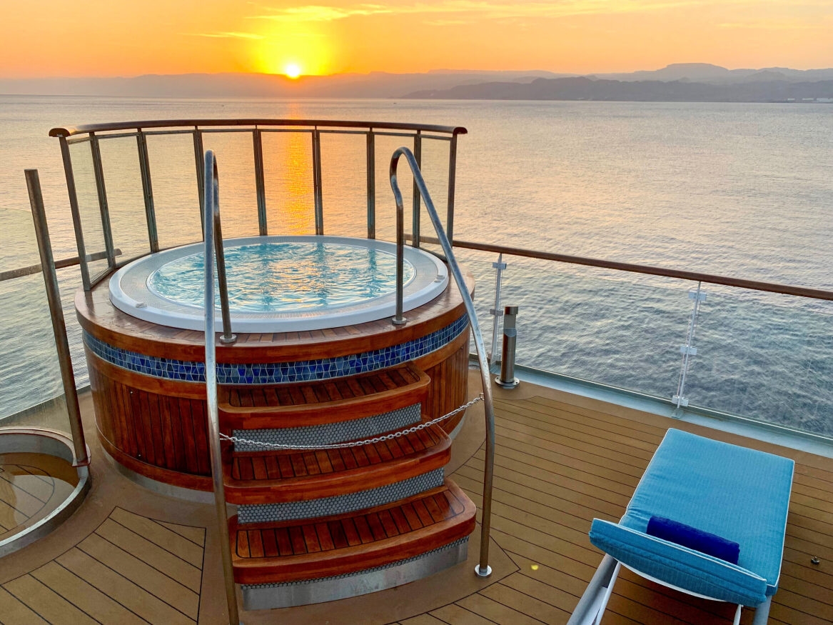 An outdoor Jacuzzi on the Ocean Explorer at sunset.