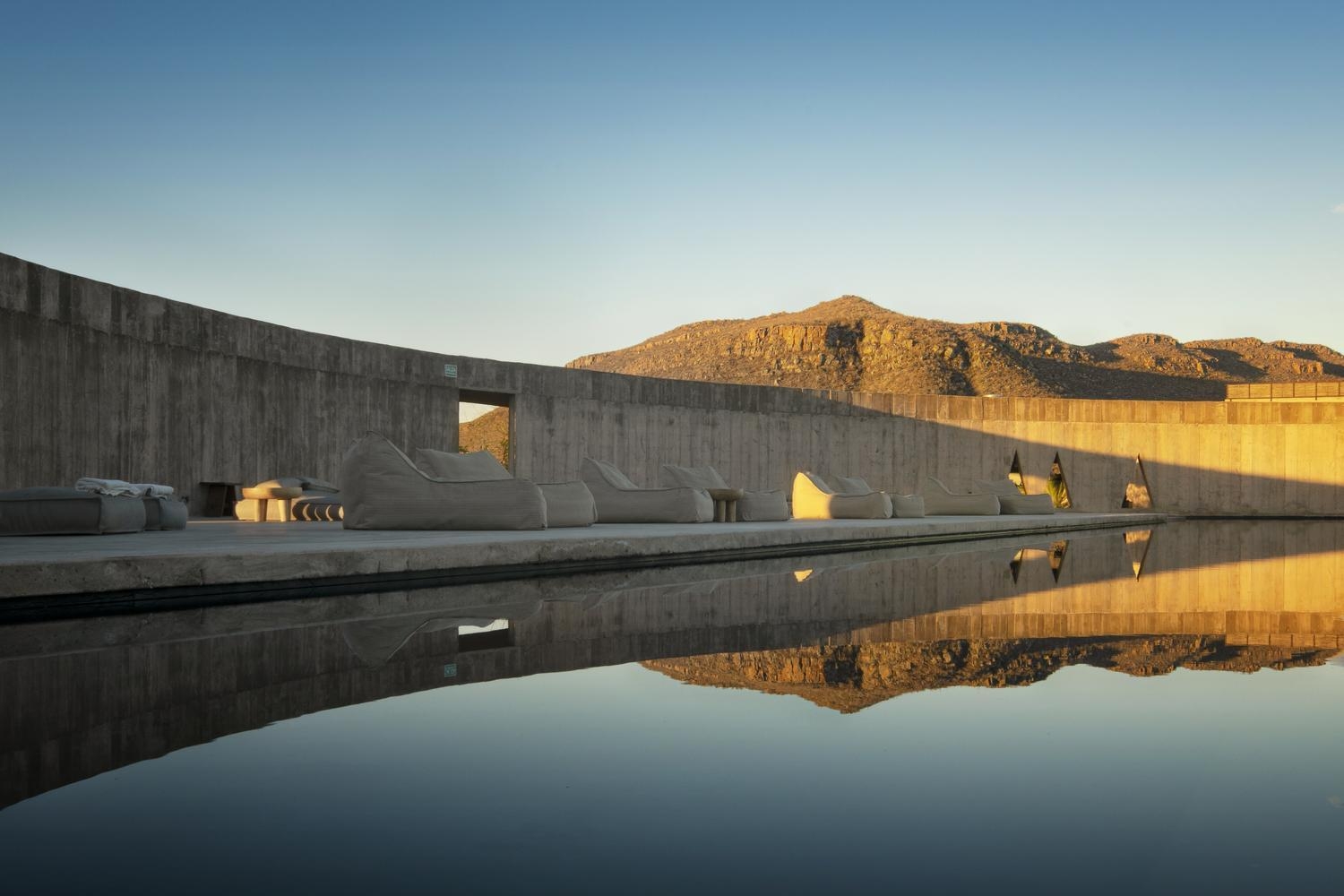 Outdoor pool with reflections on the water at Paradero in Todos Santos