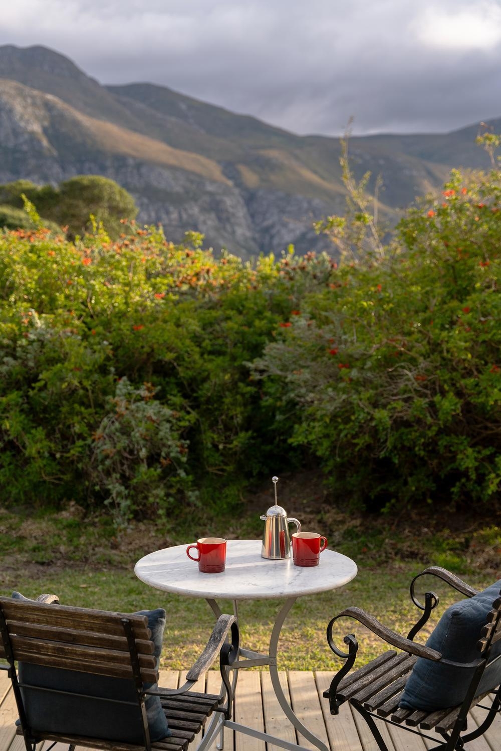 The porch of a cottage at Coot Club feature an outdoor dining area overlooking the surrounding mountains.