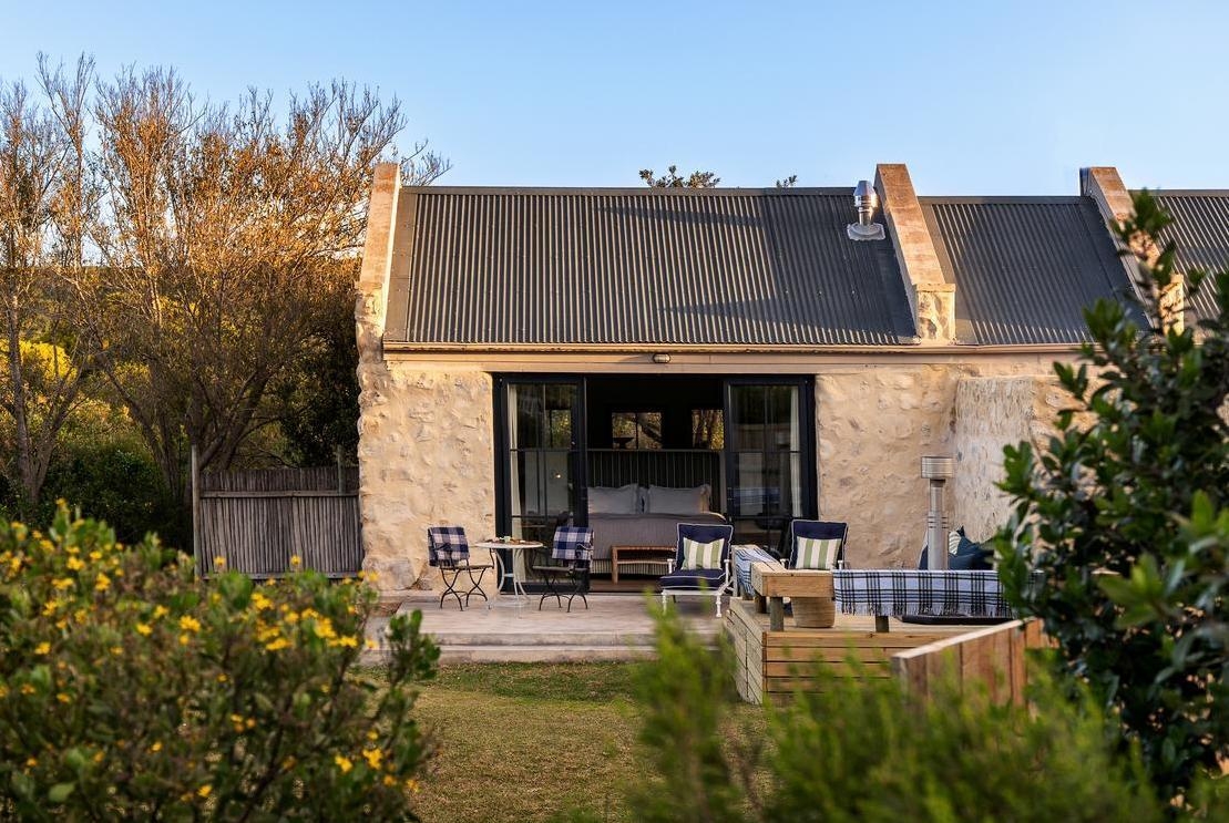 An exterior view of a stone cottage at Coot Club.