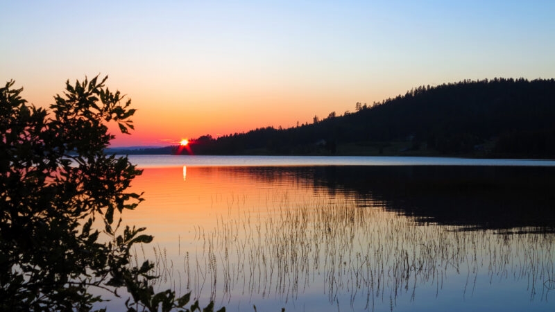 A summer picture with midnight sun on a lake