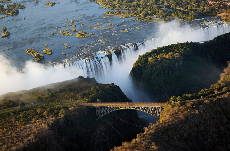 High angle view of Victoria Falls and a bridge during luxury Zambia holidays.