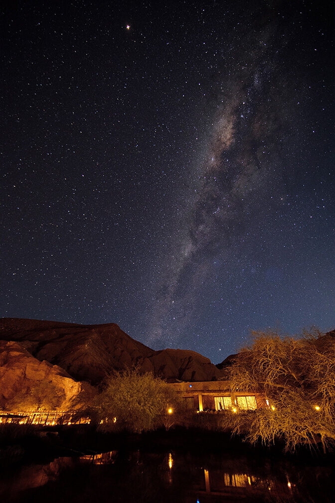 The Milky Way galaxy over a desert building at night, a highlight of luxury Chile tours.