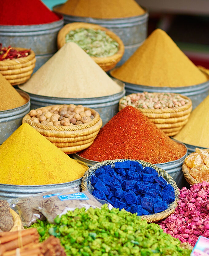Selection of pyramids of brightly coloured spices on a Moroccan market on a luxury Morocco holiday