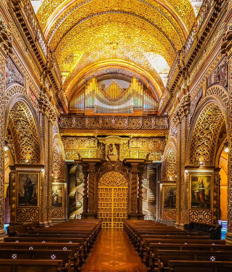 Ornate gold leaf interior of a historic church in Quito, a highlight of luxury Ecuador tours.