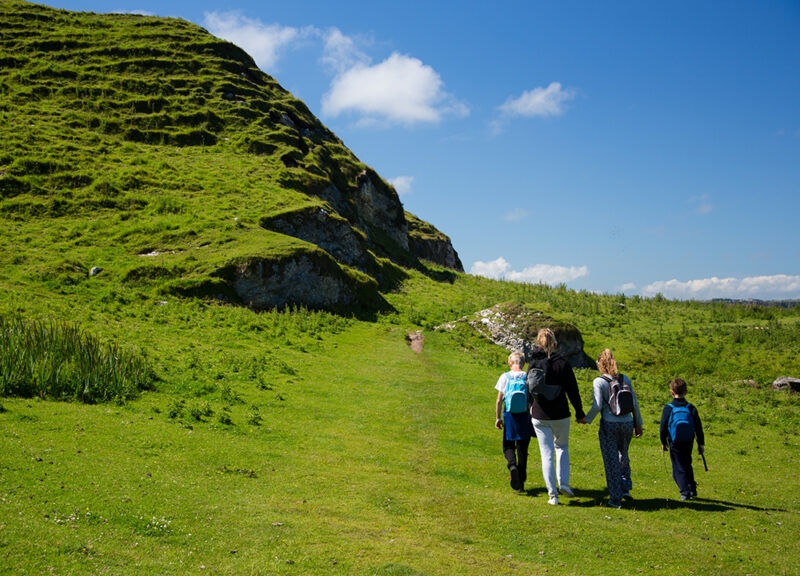 Beautiful green fields and hills of Ireland, hiking family with children