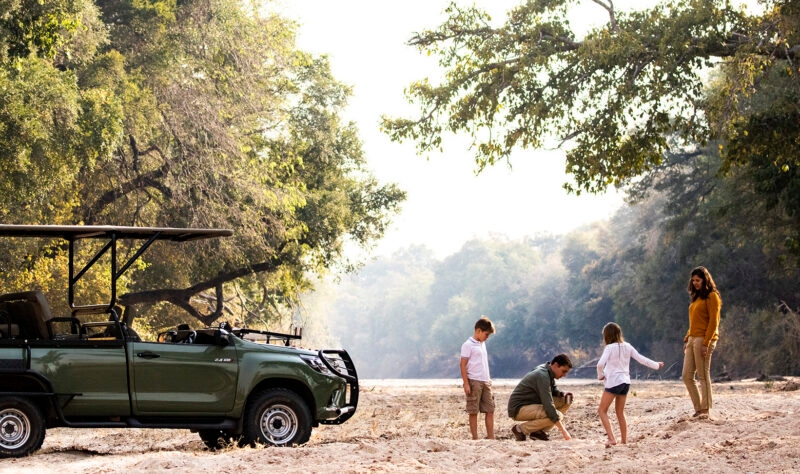 A family in front of a safari truck