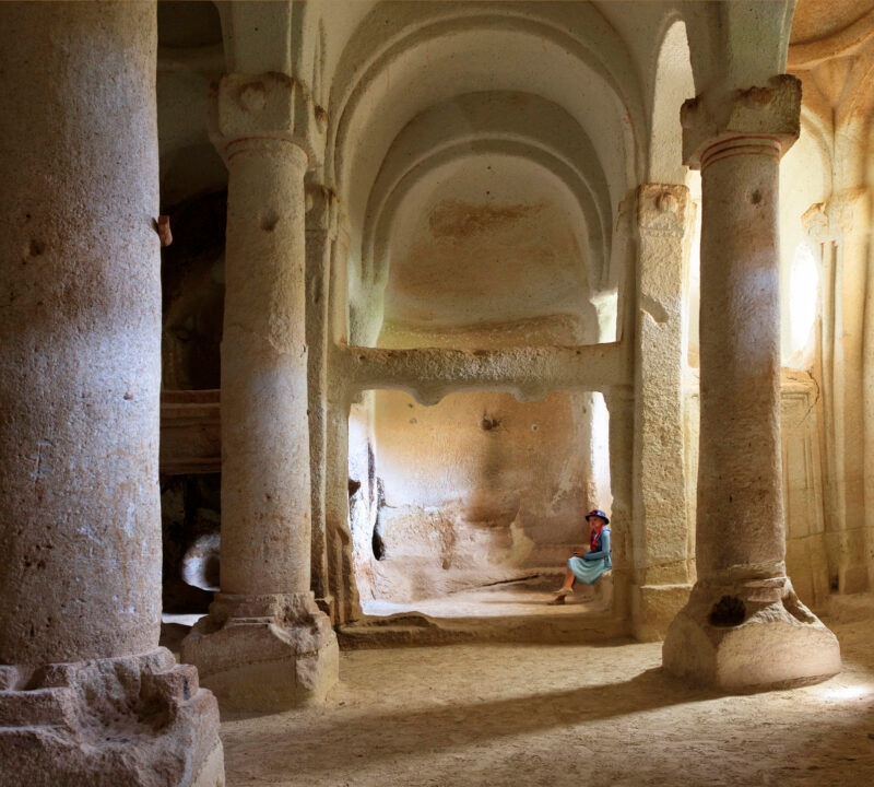 The interior of an ancient stone cave dwelling with high arches seen on luxury Turkey Asia vacations.