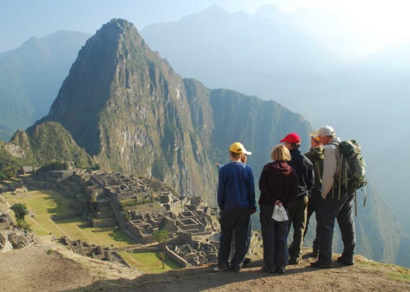 A family stood looking at Machu Picchu in the distance