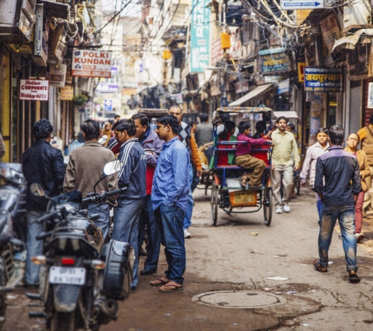 Old Delhi rickshaws are seen scattered down a busy Dehli street
