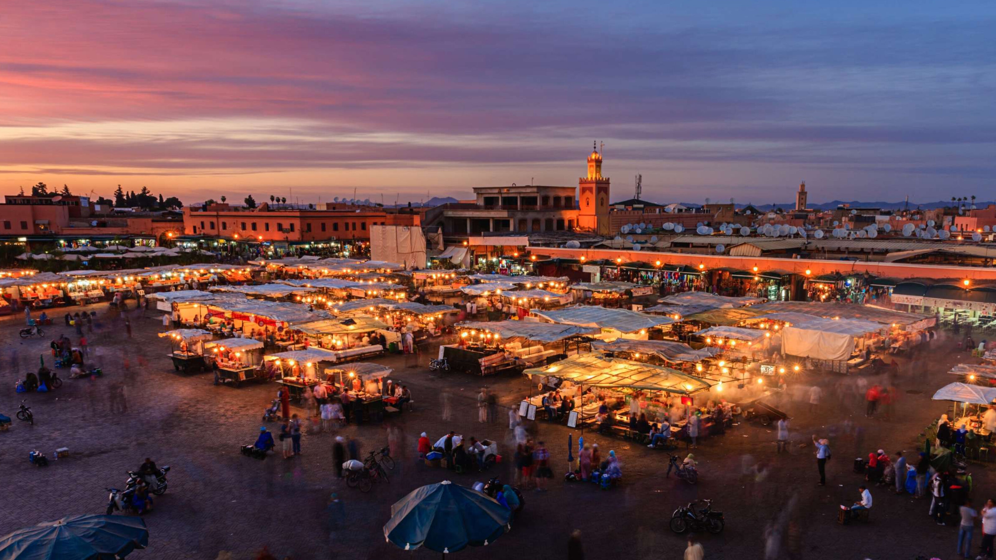 Marrakech outdoor souk with tented stalls at sunset