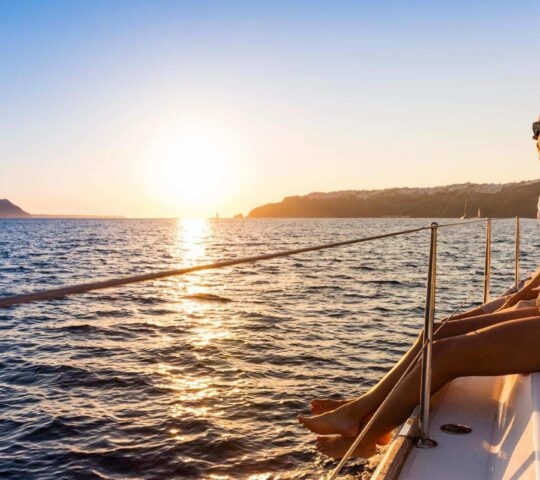 Couple at sunset on a Santorini boat cruise