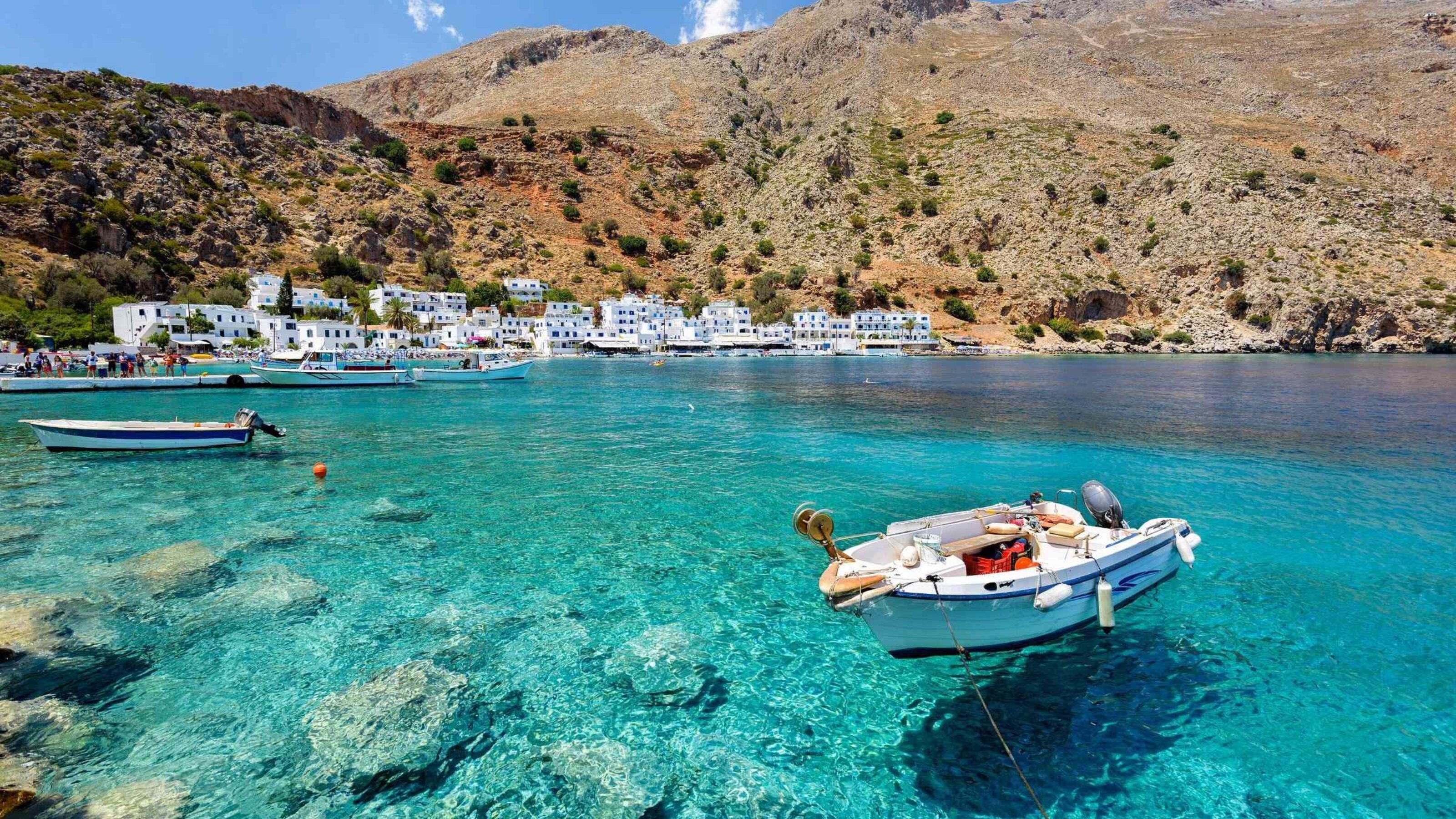 Motorboat at clear water of Loutro town on Crete island