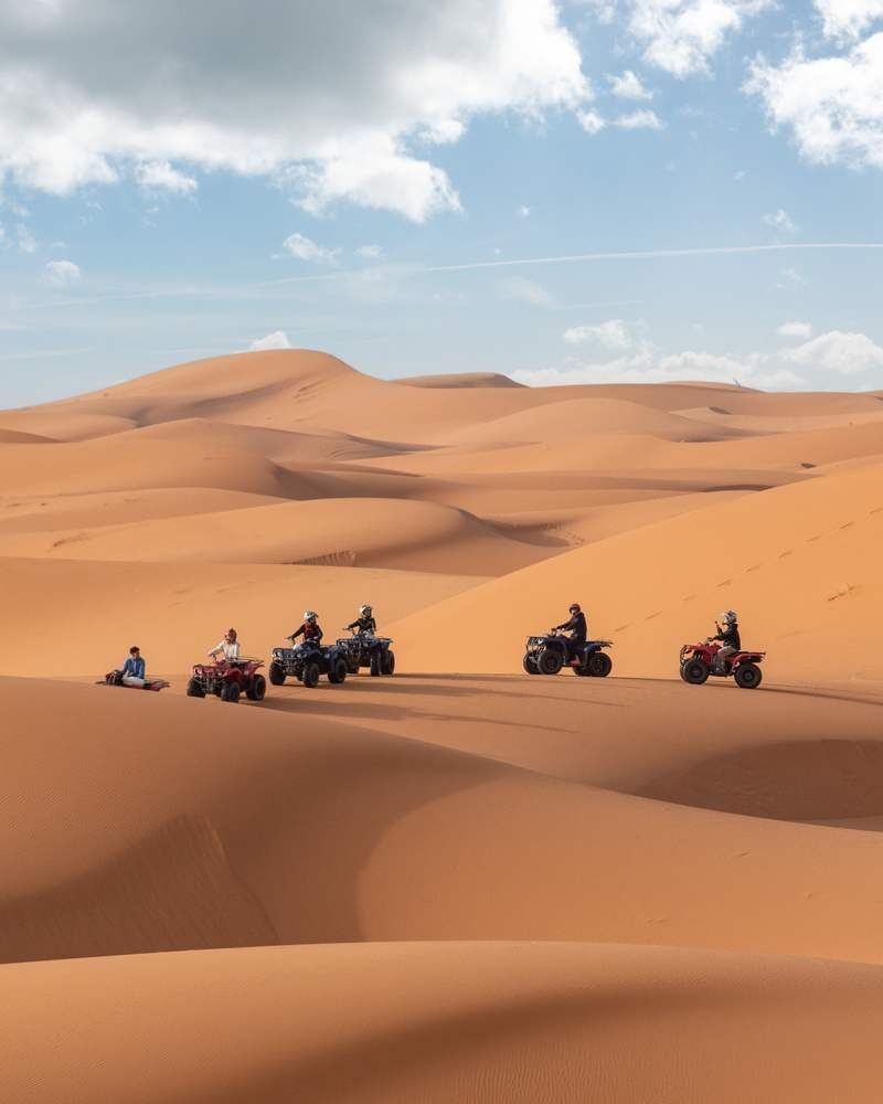 Motorbikers driving off-road in the Erg Chebbi desert near Merzouga, Morocco