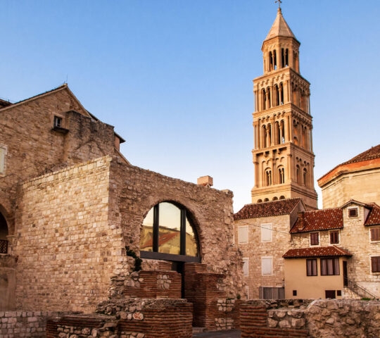 Scene from the old city of Split and the view of old bell tower in sunset
