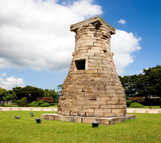 Conical stone structure in grassy garden in South Korea